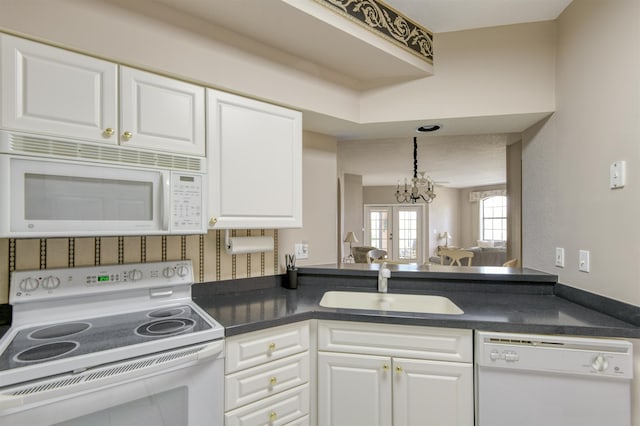 2202 Vista Cove Rd, Saint Augustine, FL 32084 - kitchen featuring white appliances, a sink, dark countertops, and white cabinets