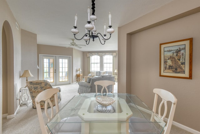 2202 Vista Cove Rd, Saint Augustine, FL 32084 - carpeted dining room with a chandelier, baseboards, arched walkways, and ceiling fan