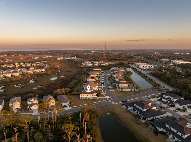 birds eye view of property featuring a water view and a residential view