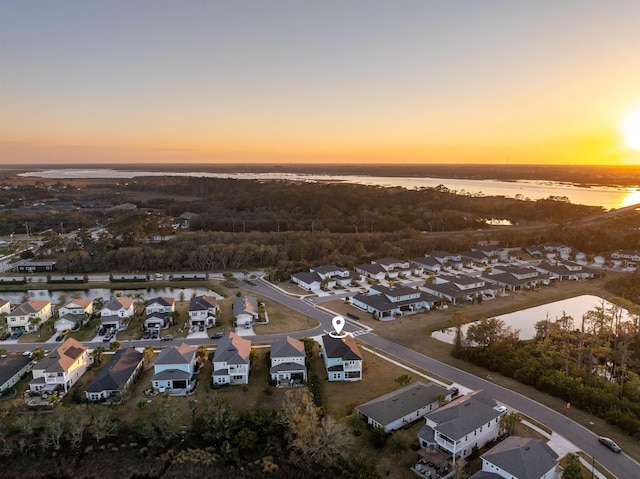 drone / aerial view featuring a water view and a residential view