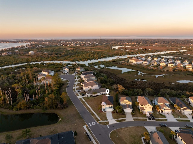 drone / aerial view featuring a residential view and a water view