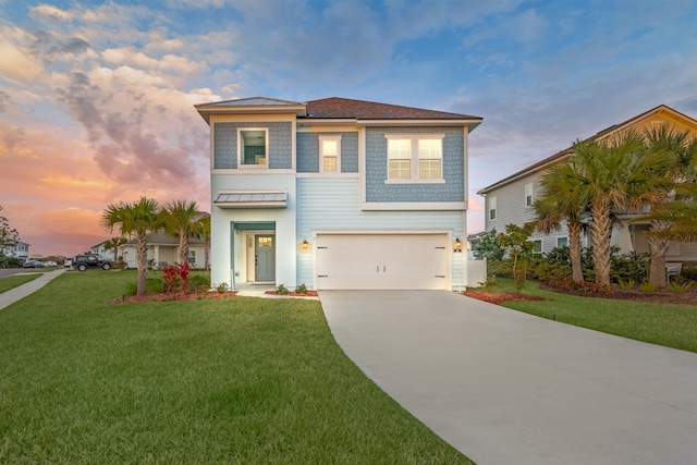 view of front of property featuring driveway, a garage, and a front lawn