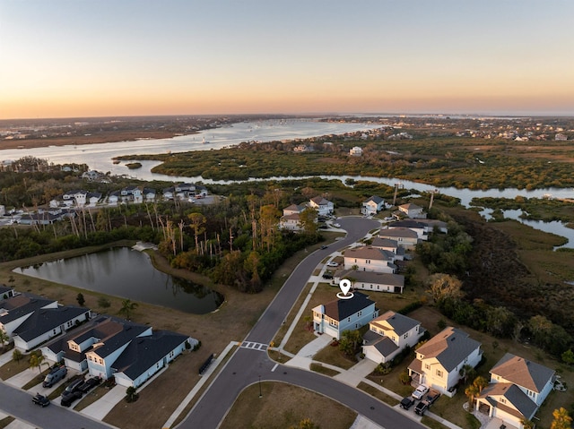 drone / aerial view featuring a water view and a residential view