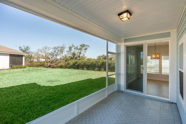 unfurnished sunroom featuring a notable chandelier