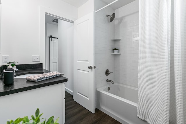 bathroom featuring vanity, shower / bathtub combination with curtain, and hardwood / wood-style flooring