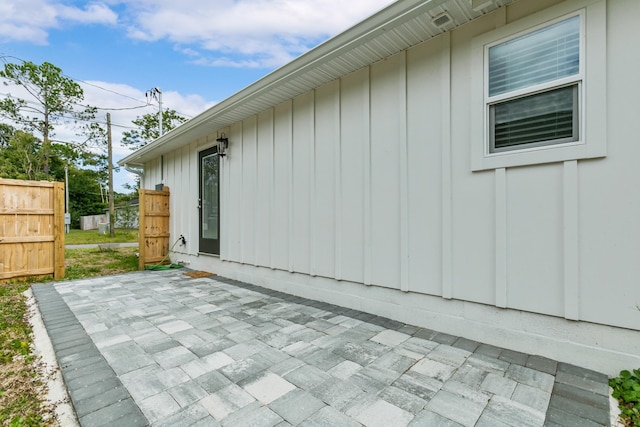 view of side of property with a patio