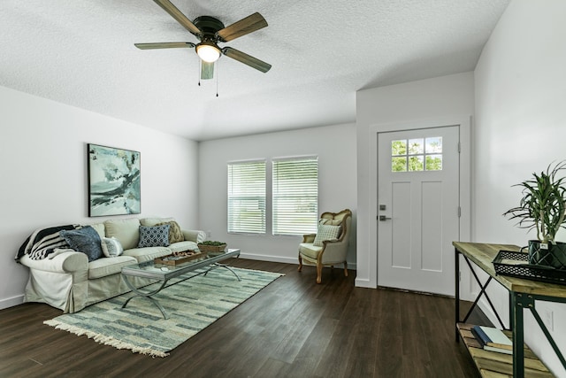 living room with plenty of natural light, dark hardwood / wood-style floors, a textured ceiling, and ceiling fan