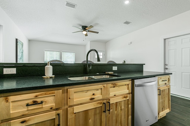 kitchen with sink, stainless steel dishwasher, dark hardwood / wood-style floors, ceiling fan, and a textured ceiling