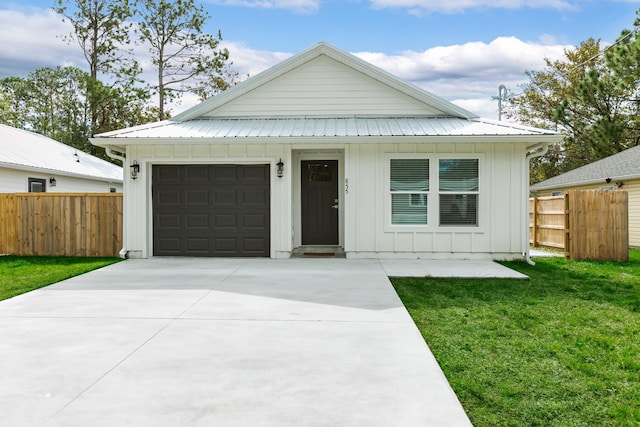 view of front of home with a garage and a front lawn