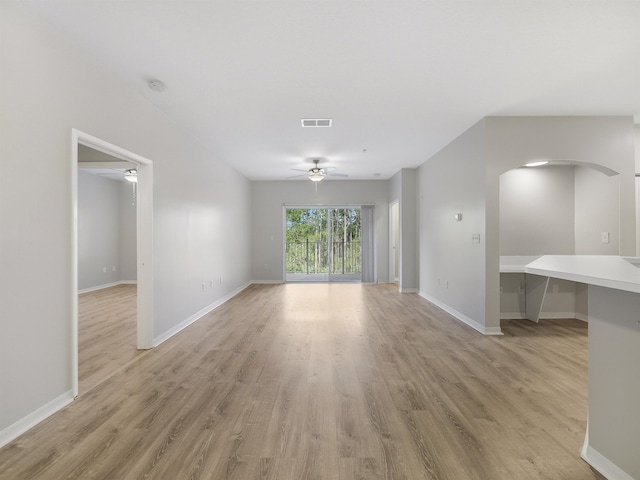 520 Florida Club Blvd Unit 310, Saint Augustine, FL 32084 - unfurnished living room featuring visible vents, a ceiling fan, arched walkways, and light wood-style floors