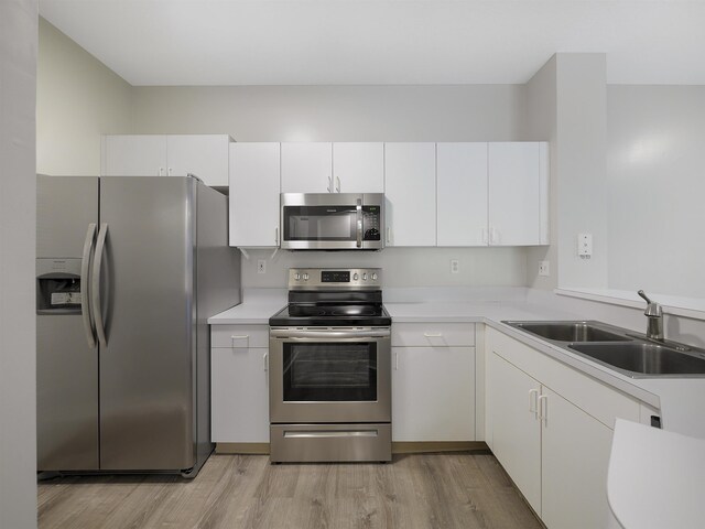 520 Florida Club Blvd Unit 310, Saint Augustine, FL 32084 - kitchen with light countertops, light wood finished floors, a sink, and stainless steel appliances