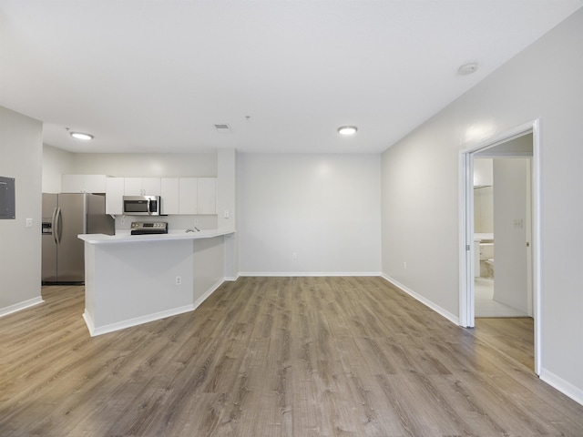 520 Florida Club Blvd Unit 310, Saint Augustine, FL 32084 - unfurnished living room with baseboards and light wood-type flooring
