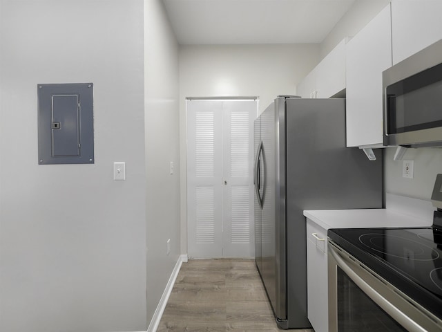 520 Florida Club Blvd Unit 310, Saint Augustine, FL 32084 - kitchen with white cabinets, electric panel, light countertops, appliances with stainless steel finishes, and light wood-style floors