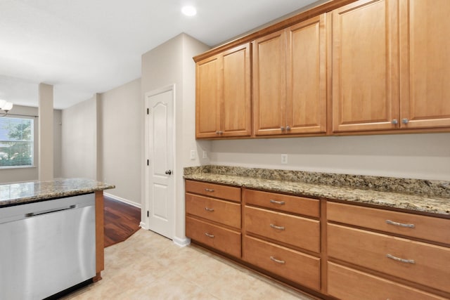 kitchen with light stone counters and dishwasher