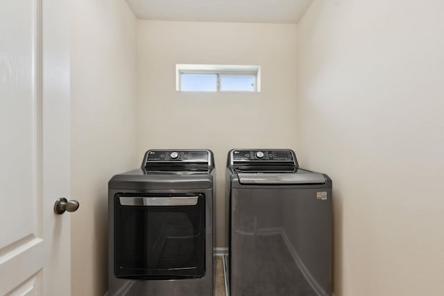 clothes washing area featuring washer and clothes dryer