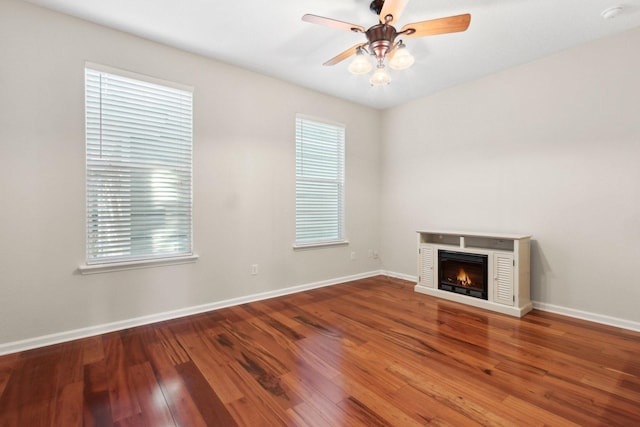 unfurnished living room featuring ceiling fan and wood-type flooring