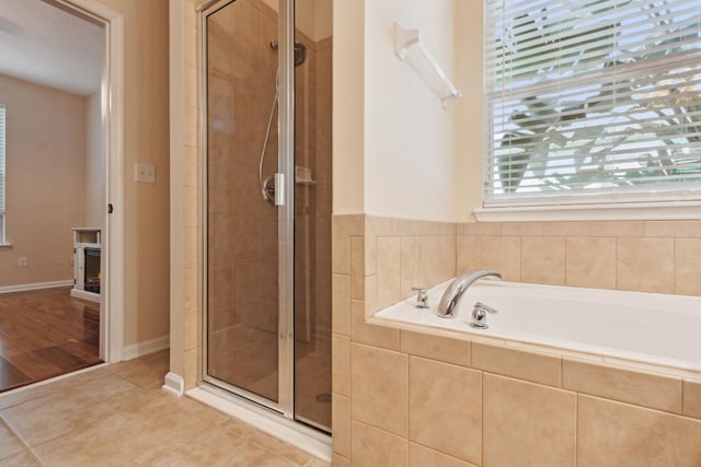 bathroom featuring tile patterned floors, a healthy amount of sunlight, and plus walk in shower