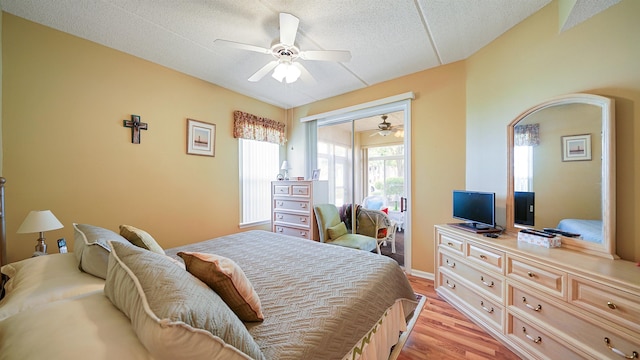 308 Augusta Cir, Saint Augustine, FL 32086 - bedroom with light wood finished floors, a textured ceiling, a ceiling fan, baseboards, and a closet