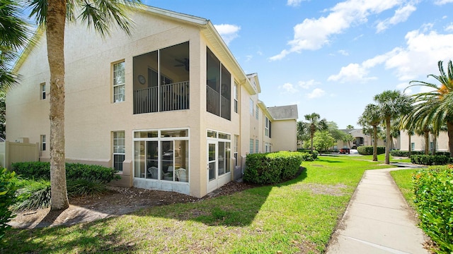 308 Augusta Cir, Saint Augustine, FL 32086 - view of side of home with a lawn, ceiling fan, and stucco siding