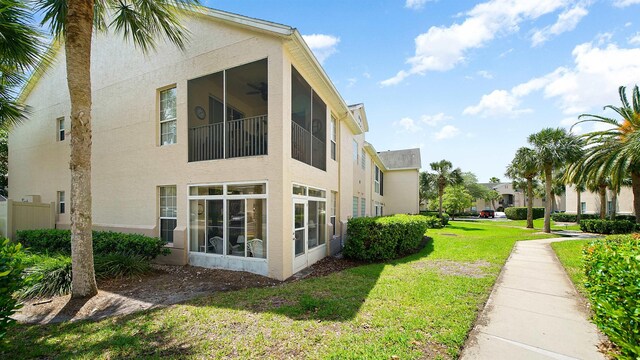 308 Augusta Cir, Saint Augustine, FL 32086 - view of side of home with a lawn, ceiling fan, and stucco siding