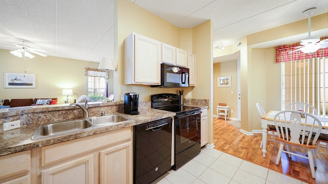 308 Augusta Cir, Saint Augustine, FL 32086 - kitchen with a textured ceiling, open floor plan, a sink, and black appliances