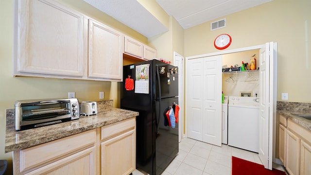 308 Augusta Cir, Saint Augustine, FL 32086 - kitchen with visible vents, a toaster, freestanding refrigerator, separate washer and dryer, and light tile patterned flooring