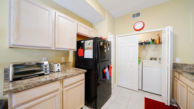 308 Augusta Cir, Saint Augustine, FL 32086 - kitchen with visible vents, a toaster, freestanding refrigerator, separate washer and dryer, and light tile patterned flooring
