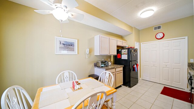 308 Augusta Cir, Saint Augustine, FL 32086 - kitchen with freestanding refrigerator, ceiling fan, visible vents, and light tile patterned floors