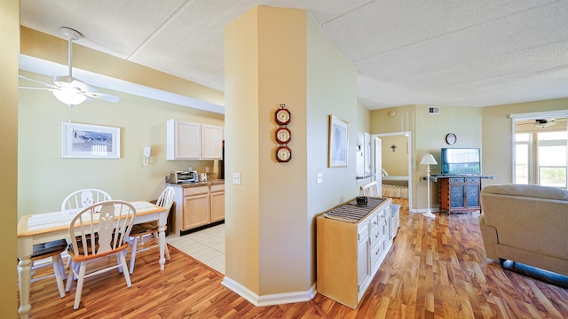 308 Augusta Cir, Saint Augustine, FL 32086 - kitchen featuring a ceiling fan, a textured ceiling, light wood-type flooring, baseboards, and open floor plan