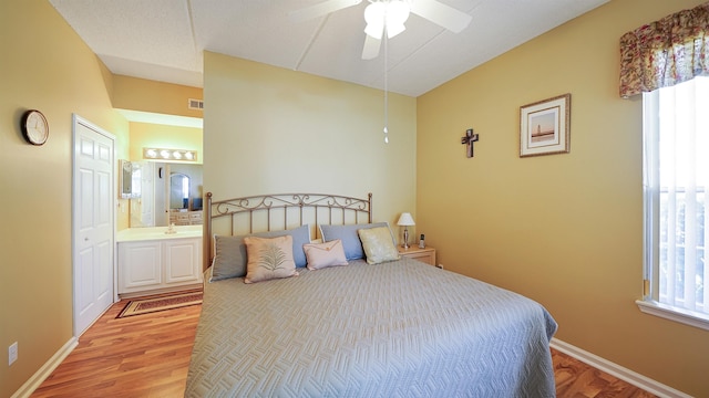 308 Augusta Cir, Saint Augustine, FL 32086 - bedroom with connected bathroom, ceiling fan, light wood finished floors, baseboards, and visible vents