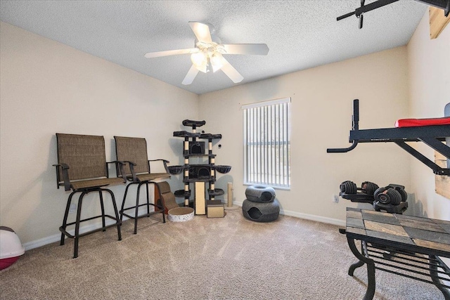 workout room with ceiling fan, a textured ceiling, and carpet flooring