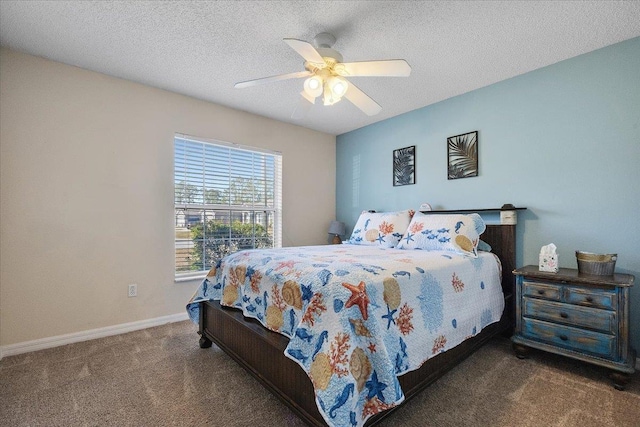 bedroom with ceiling fan, dark carpet, and a textured ceiling