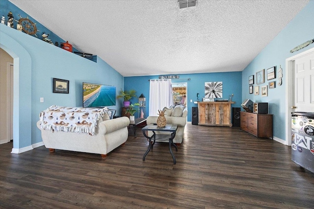 living room with vaulted ceiling, dark hardwood / wood-style floors, and a textured ceiling