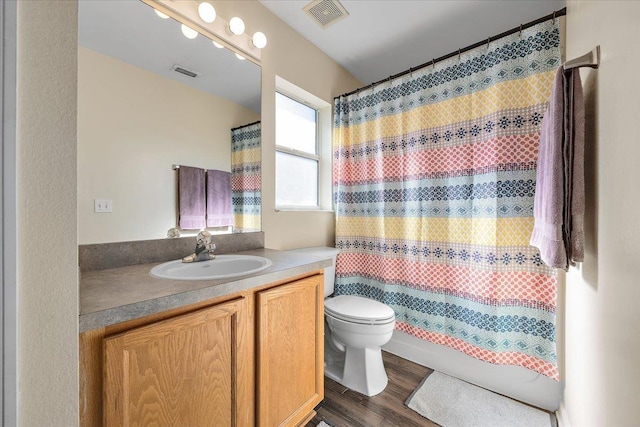 bathroom featuring vanity, hardwood / wood-style floors, a shower with curtain, and toilet