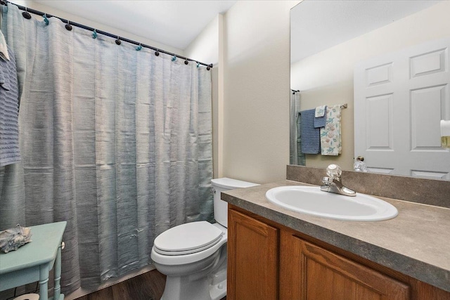 bathroom with vanity, hardwood / wood-style flooring, and toilet