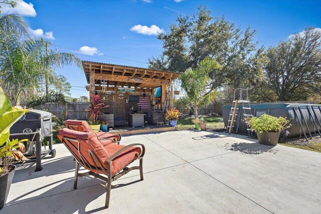 view of patio / terrace with a hot tub and a pergola