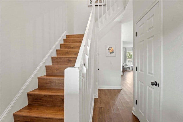 28 S Comares Ave, Saint Augustine, FL 32080 - stairs with wood finished floors, baseboards, and a towering ceiling