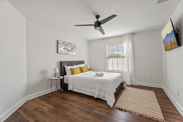 28 S Comares Ave, Saint Augustine, FL 32080 - bedroom featuring wood finished floors, a textured ceiling, baseboards, and a ceiling fan
