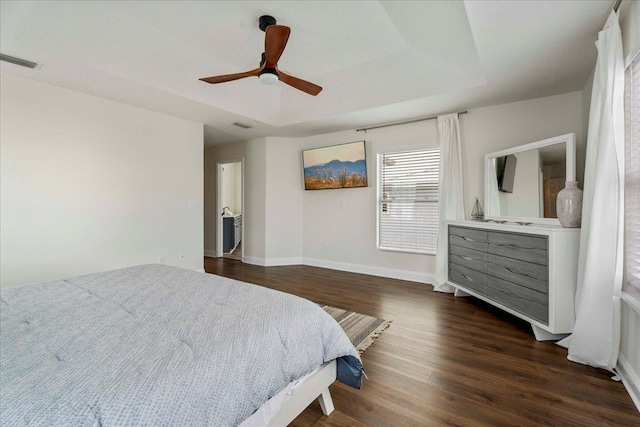 28 S Comares Ave, Saint Augustine, FL 32080 - bedroom featuring dark wood finished floors, baseboards, a ceiling fan, and a raised ceiling