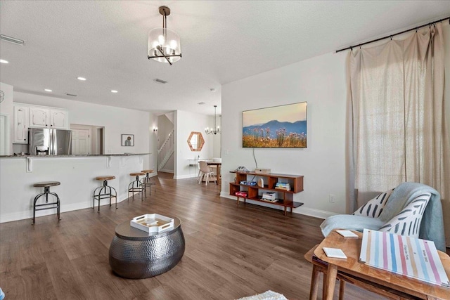 28 S Comares Ave, Saint Augustine, FL 32080 - living area with a chandelier, dark wood finished floors, baseboards, recessed lighting, and a textured ceiling
