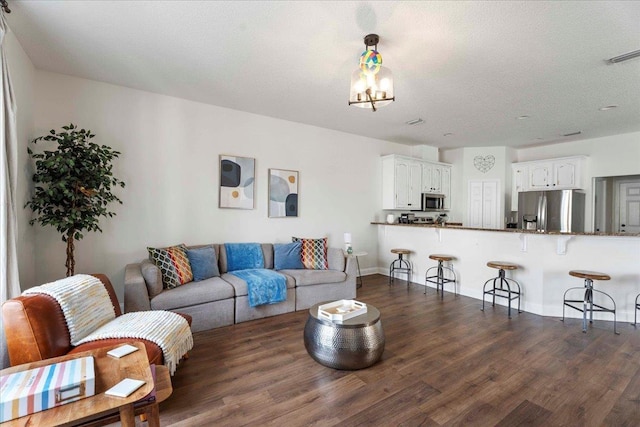 28 S Comares Ave, Saint Augustine, FL 32080 - living room featuring dark wood-type flooring and baseboards