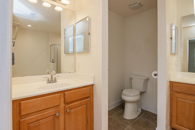 bathroom with walk in shower, tile patterned floors, toilet, and vanity