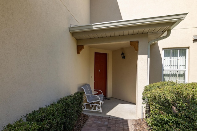 entrance to property featuring a patio