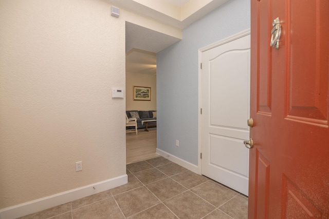 hall with tile patterned flooring