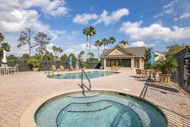 view of swimming pool with a patio and a community hot tub