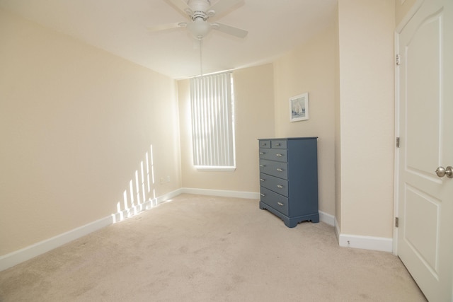 unfurnished bedroom featuring light carpet and ceiling fan