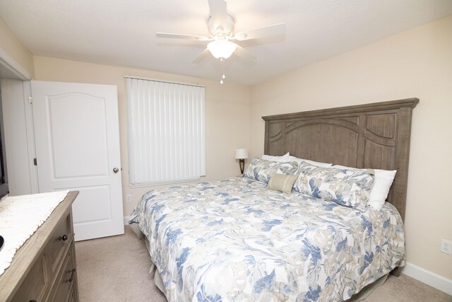 bedroom with light colored carpet and ceiling fan