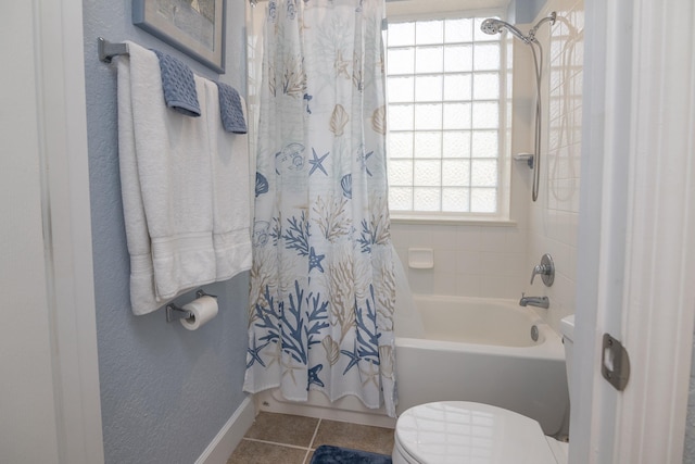 bathroom featuring shower / tub combo with curtain, toilet, and tile patterned flooring
