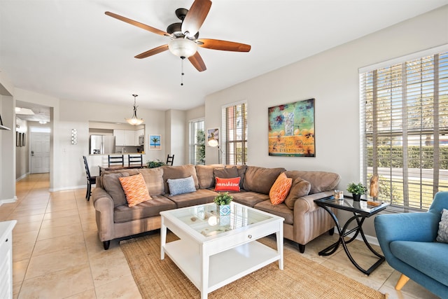 living room with ceiling fan and light tile patterned flooring