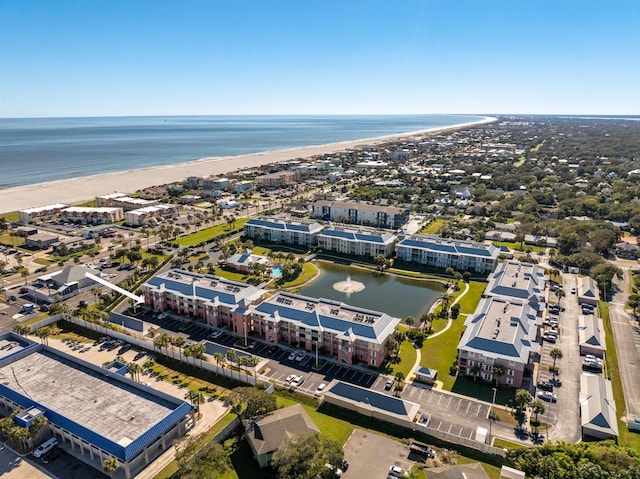 birds eye view of property with a water view and a view of the beach